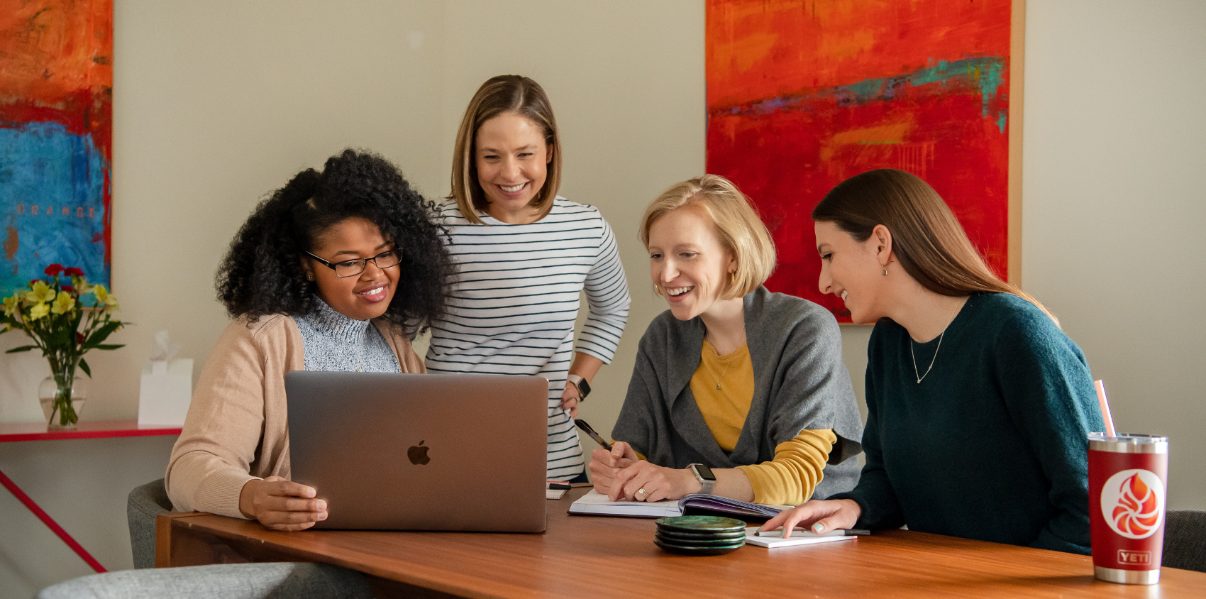 Four women looking at the PCAOB workshop